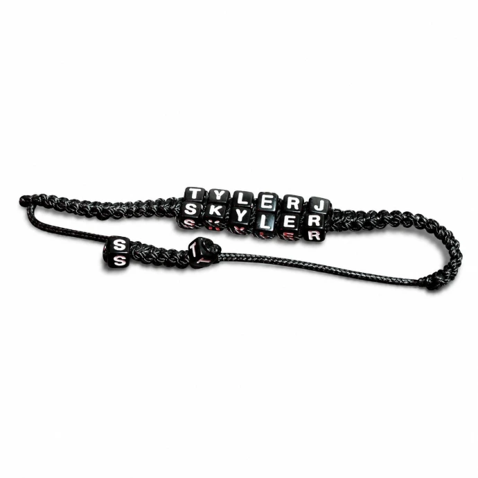 Custom black braided letter bracelet personalized with the names SKYLER and TYLER using cube alphabet beads.